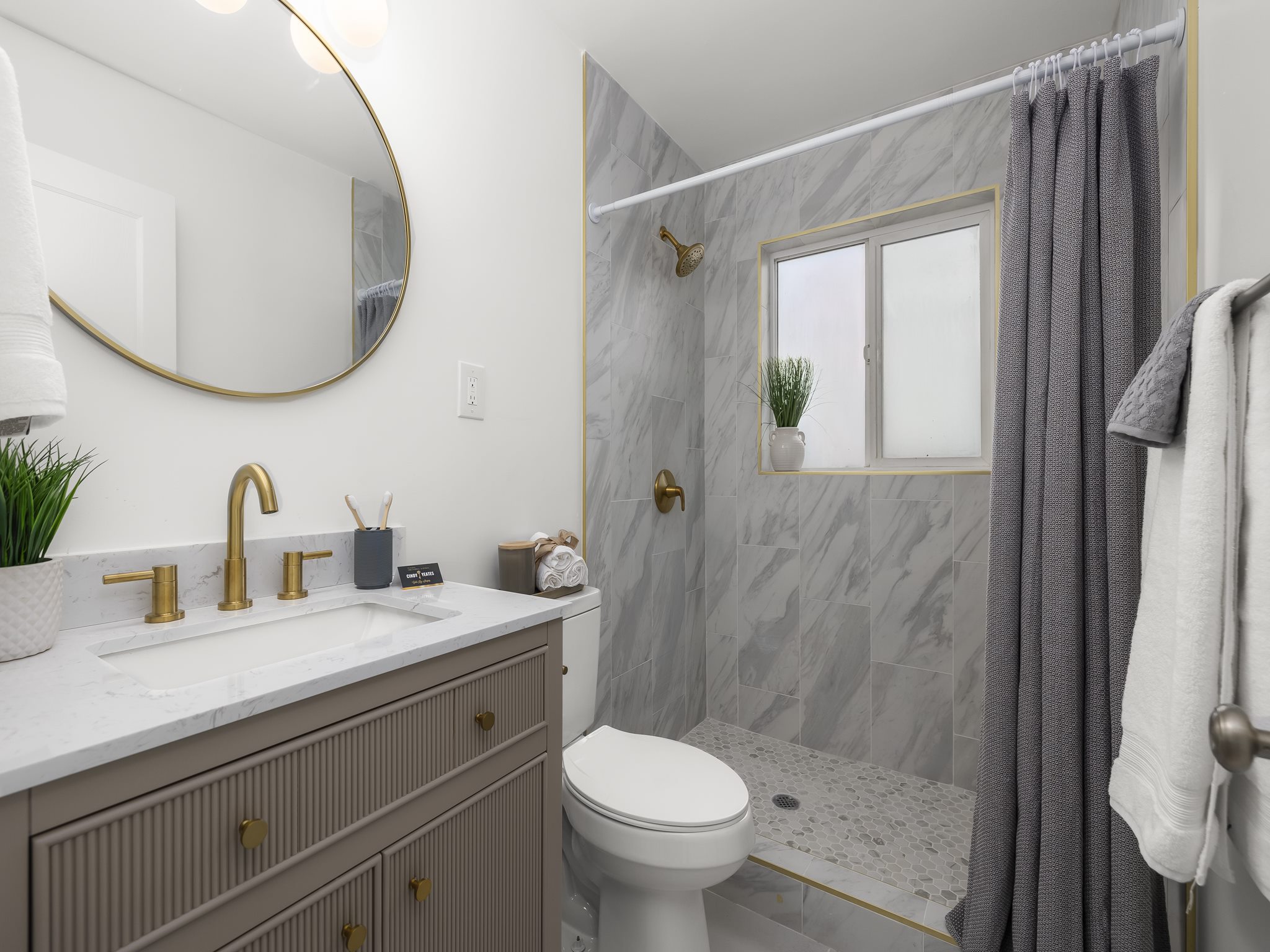 Luxury bathroom with gold fixtures inside a finished Utah ADU